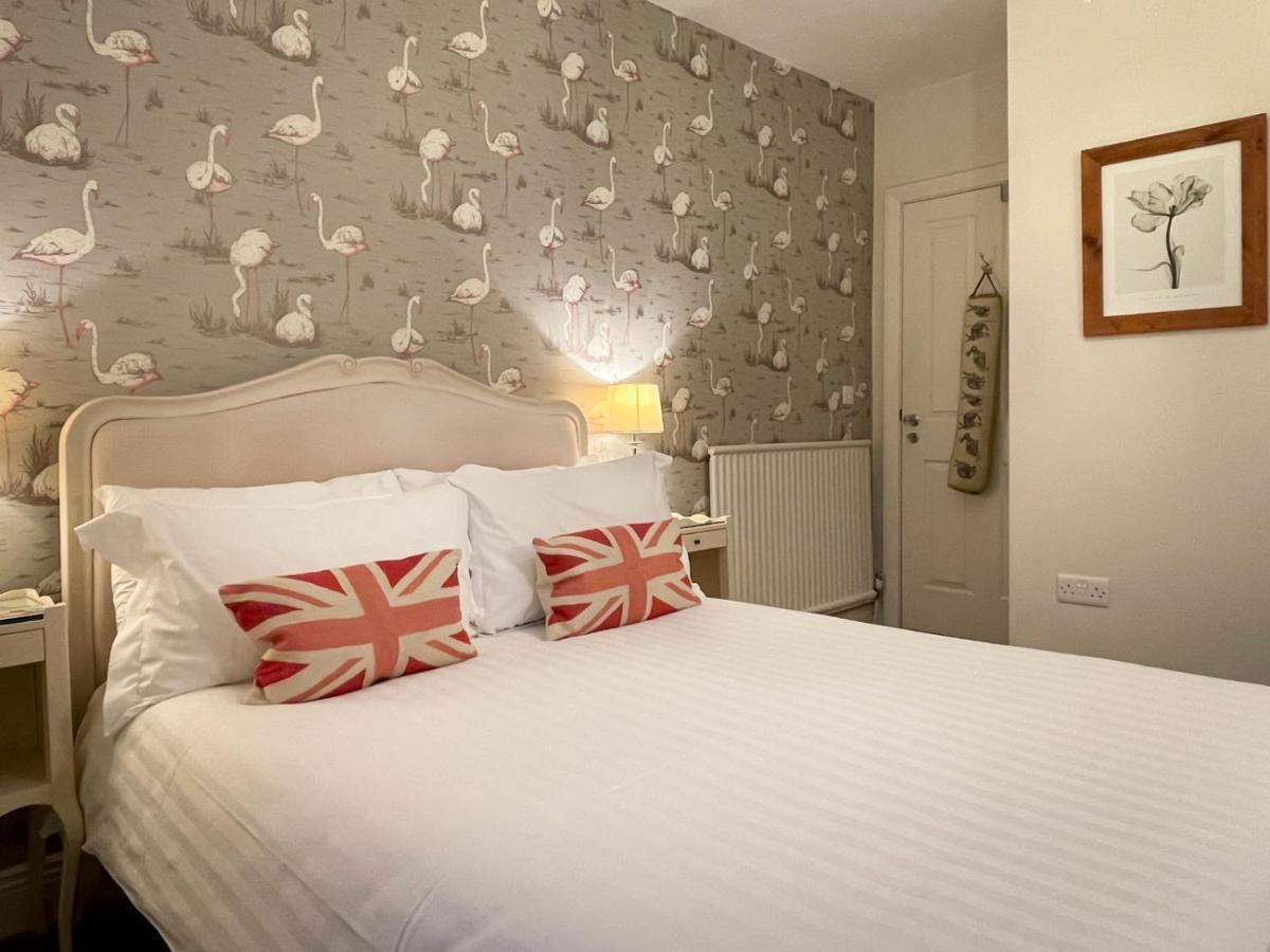 Double room with grey floral wallpaper