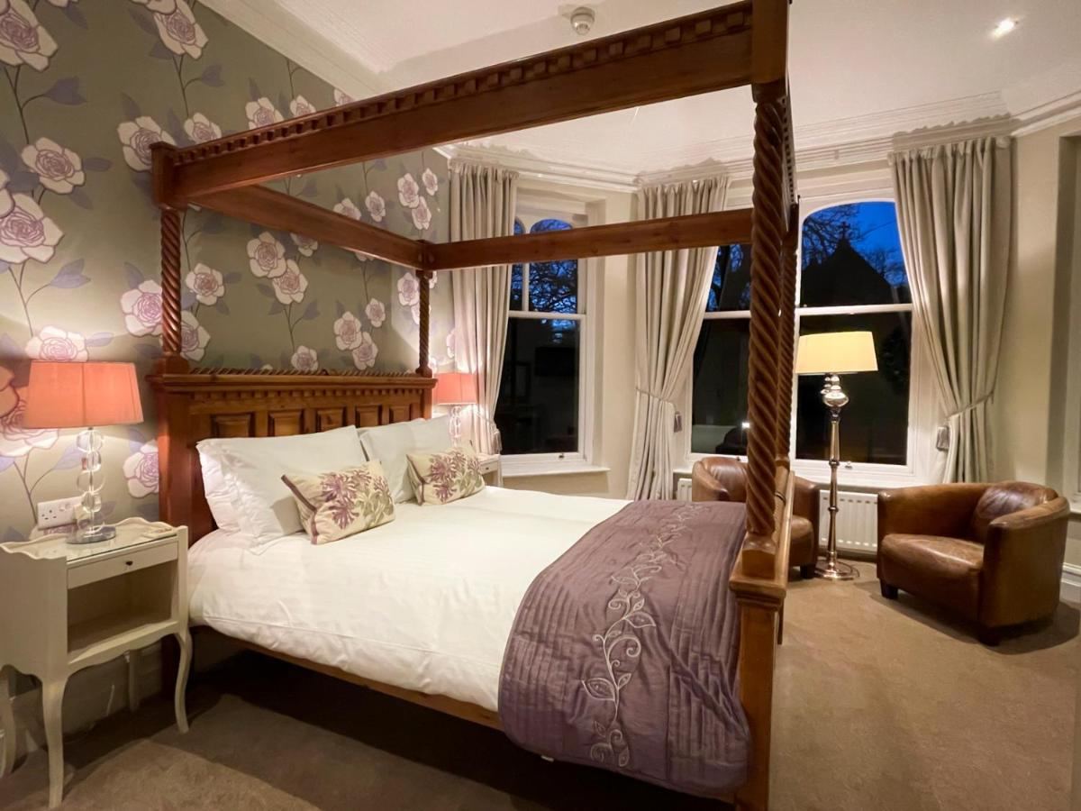 Four-poster room with bay window at night