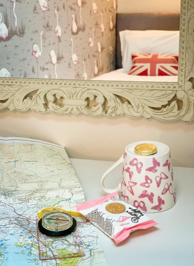 Map, mug and biscuits on a table at Rosemount Guest House
